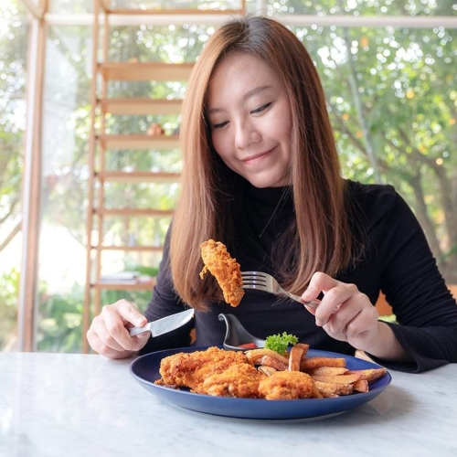 Women eating nice plant-based fish fingers